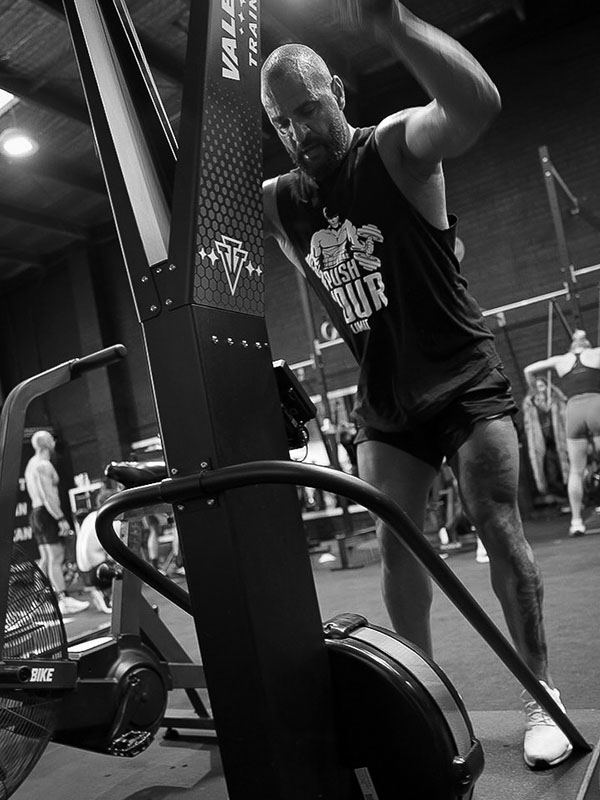 Vale Tudo Training DryAthlon athlete competitor working out intensely on ski erg machine