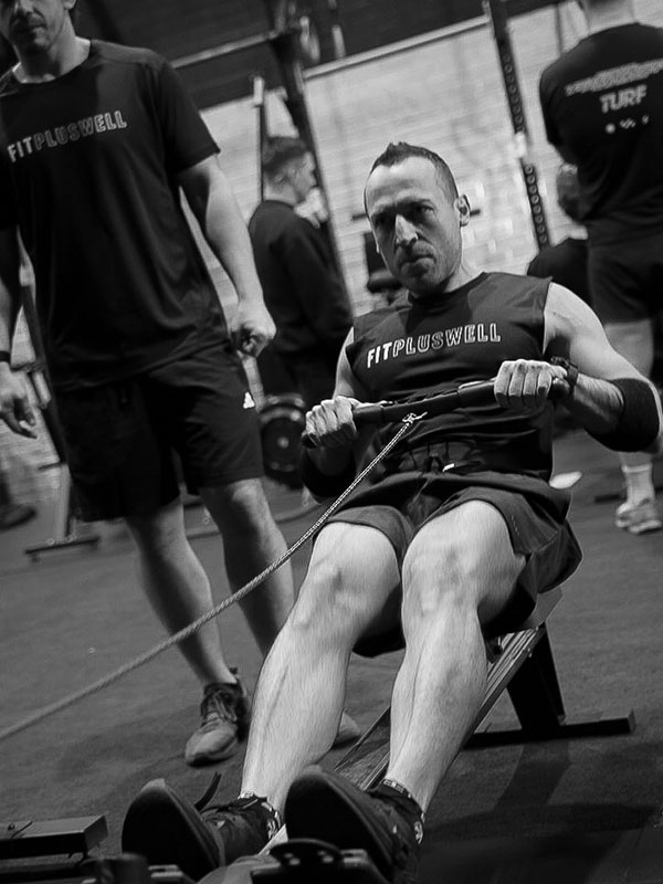 Vale Tudo Training DryAthlon athlete competitor rowing intensely on a rowing machine