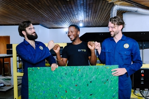 three men cheering with a recycled plate