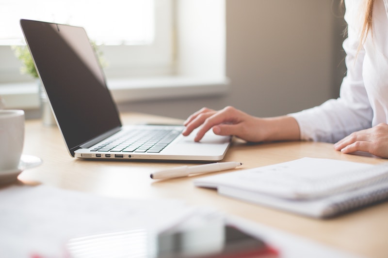 Female preparing taxes online using a laptop