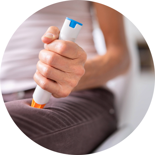 Woman sticking an EpiPen in her thigh to stop her severe allergic reaction known as Anaphylaxis.