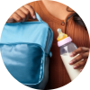 Mother holding a cooler bag and a bottle of expressed breastmilk, symbolizing working parent support for breastfeeding and proper milk storage.