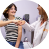 BASS nurse practitioner fist-bumping a young girl in a medical exam room after a successful, stress-free annual checkup.