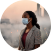 Young woman outdoors in a city, surrounded by air pollution—representing environmental lung cancer risk in non-smokers.