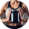 Person in workout clothes holding a container of protein powder, suggesting a focus on fitness and supplementation.