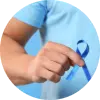 Man wearing blue t-shirt and holding a blue ribbon for Prostate Cancer Awareness Month.