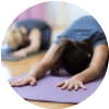 Woman practicing yoga at home for pain relief.