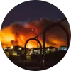 California wildfire blazing at night above residential area.