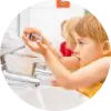 Elementary school kids washing their hands to avoid getting sick.