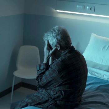 Older man experiencing extreme dizziness, possibly due to vertigo or inner ear issues.