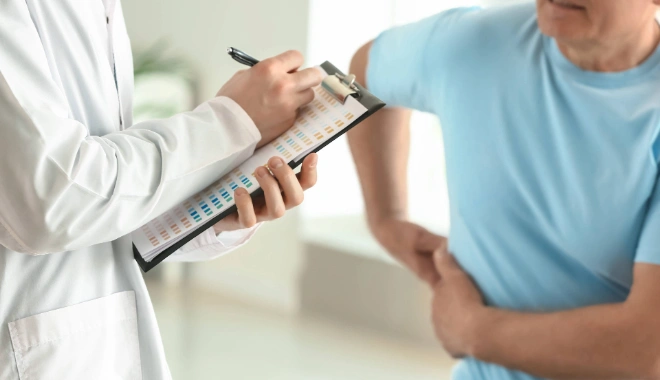 Middle-aged man with side abdomen pain caused by kidney stones, awaiting diagnosis by the urologist.