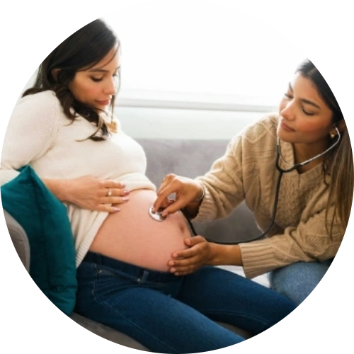 Certified nurse midwife performing an at-home prenatal checkup, listening to a pregnant woman’s abdomen with a stethoscope during a home visit.