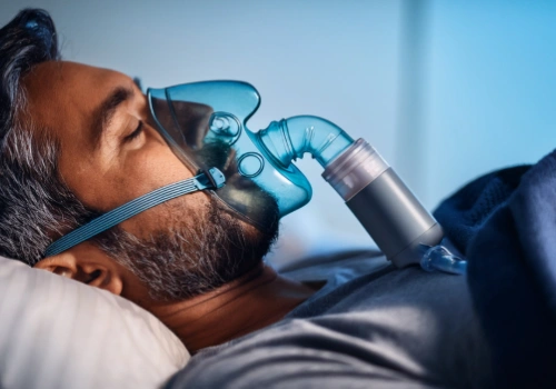 Adult patient wearing a CPAP mask while sleeping, illustrating common treatment for sleep apnea.
