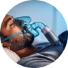 Adult patient wearing a CPAP mask while sleeping, illustrating common treatment for sleep apnea.