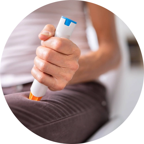 Woman sticking an EpiPen in her thigh to stop her severe allergic reaction known as Anaphylaxis.