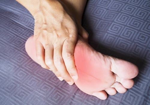 Women suffering from diabetic neuropathy in her feet and massaging her soles to relieve the pain.