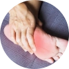 A person massaging their heel that's inflamed due to plantar fasciitis.