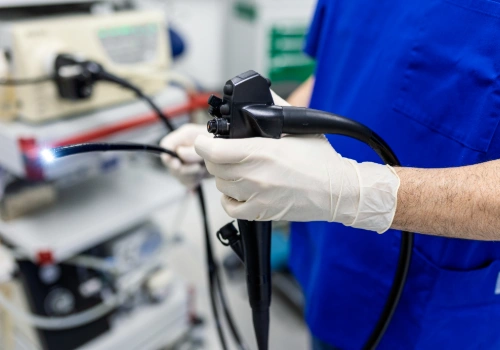 Doctor holding a colonoscope used during colonoscopy screening procedure.