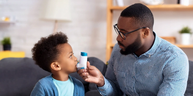 A child being comforted by a parent during a mild asthma episode