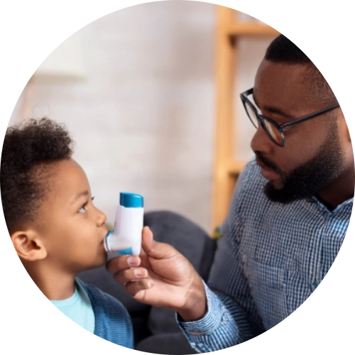 A child being comforted by a parent during a mild asthma episode