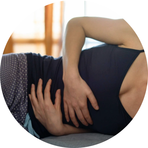 Woman experiencing abdominal discomfort consistent with irritable bowel syndrome