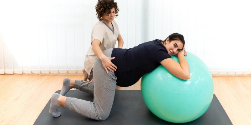 Patient working with a physical therapist on pelvic floor rehabilitation exercises
