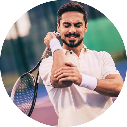 Tennis player holding his elbow in discomfort