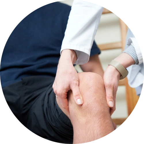 Doctor assessing an anterior cruciate ligament injury by performing a knee stability test