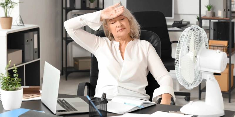 Woman experiencing hot flashes associated with menopause