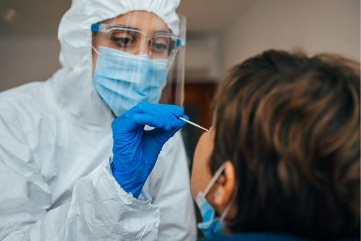 Child receiving a nasal swab for COVID-19 testing