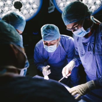 Surgeons in an operating room with bright lights
