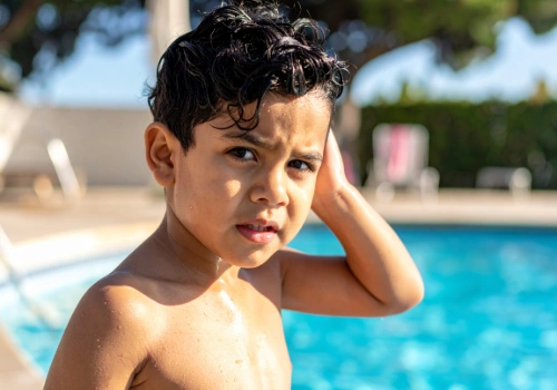 Child experiencing ear pain after swimming in a pool