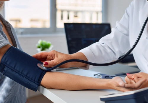 Doctor taking a patient's blood pressure reading