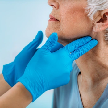 Older woman getting her thyroid and lymph nodes examined