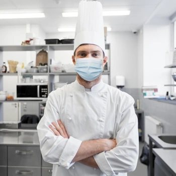 Chef wearing a mask in the kitchen