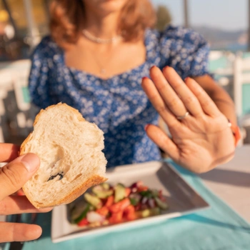 Teenage girl with celiac rejecting bread in the cafeteria