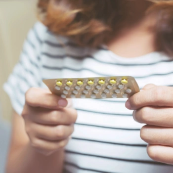 Woman holding a blister pack of birth control pills