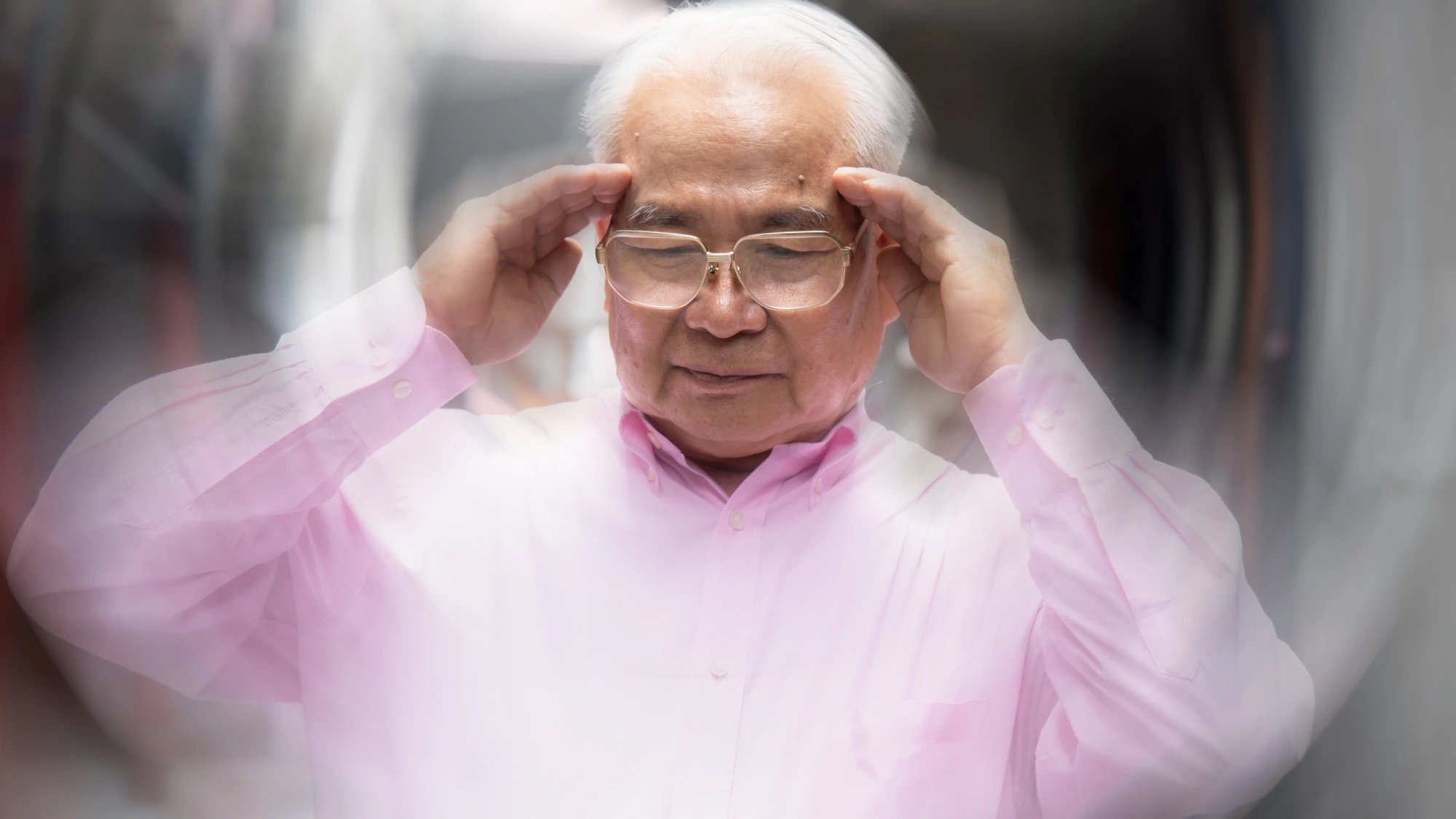 Older man experiencing extreme vertigo and dizziness while walking