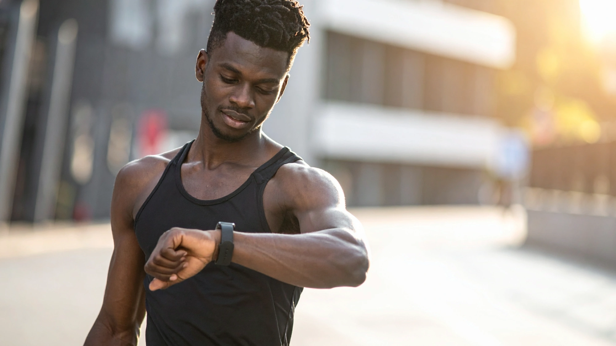 Jogger checking his health metrics on his smartwatch