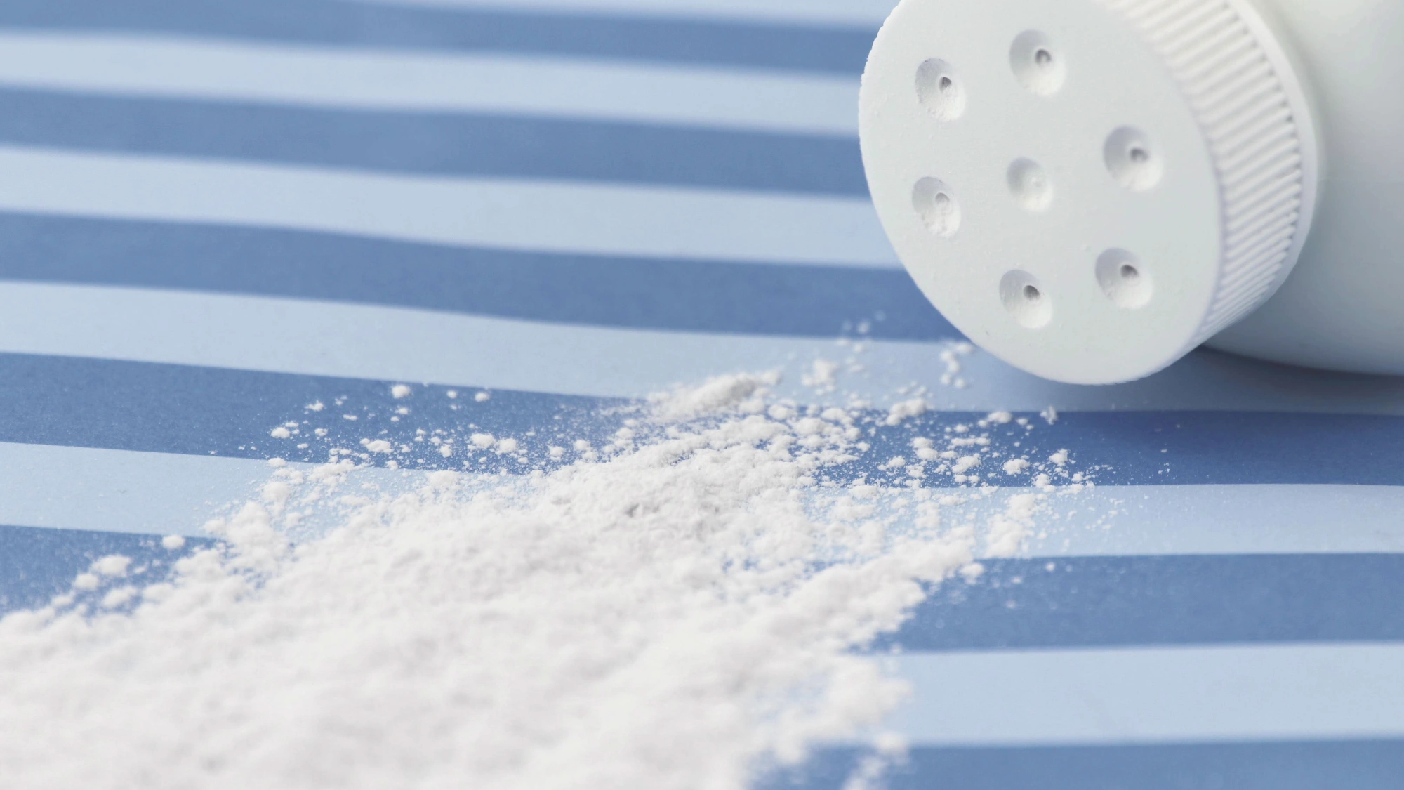 A bottle of baby powder spilled over on its side