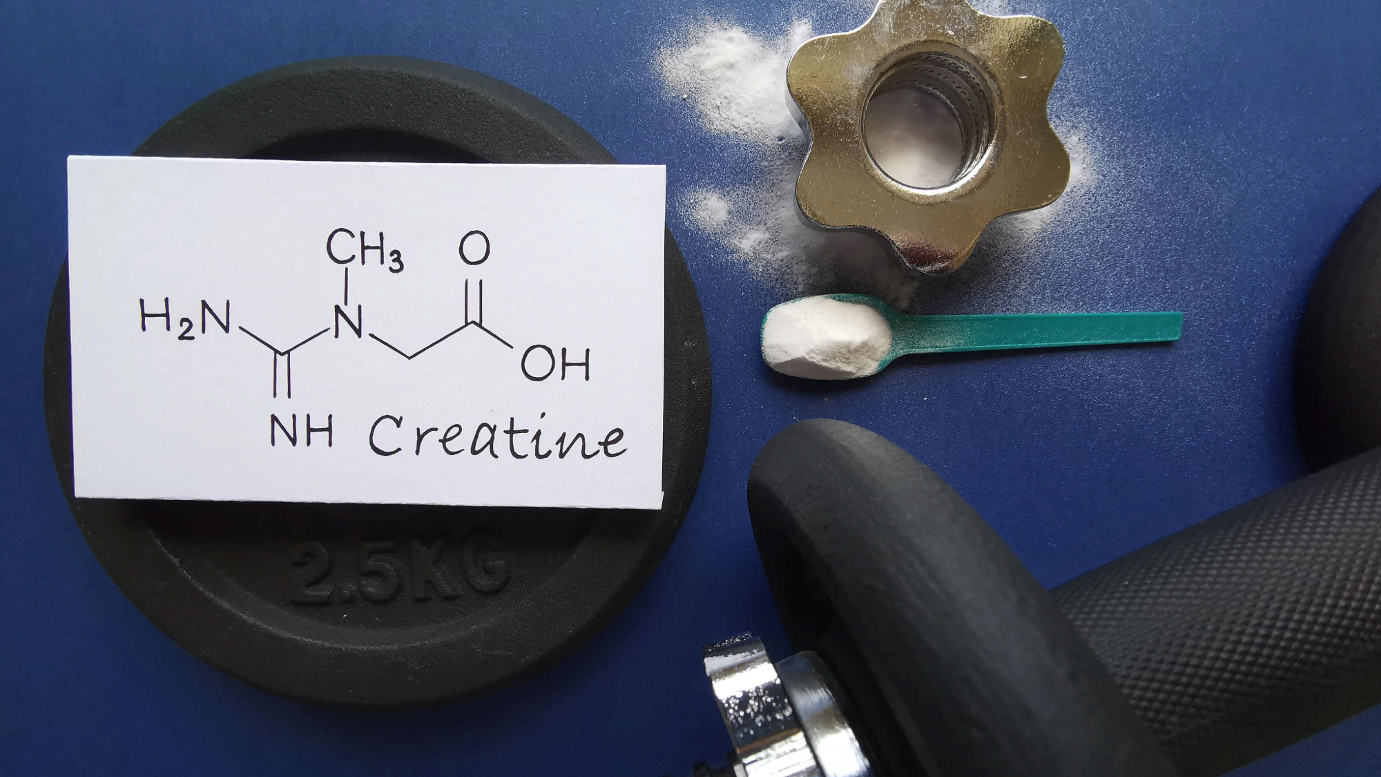 Creatine powder in a scoop beside a dumbbell and the chemical structure of creatine, representing sports nutrition and bodybuilding supplements.