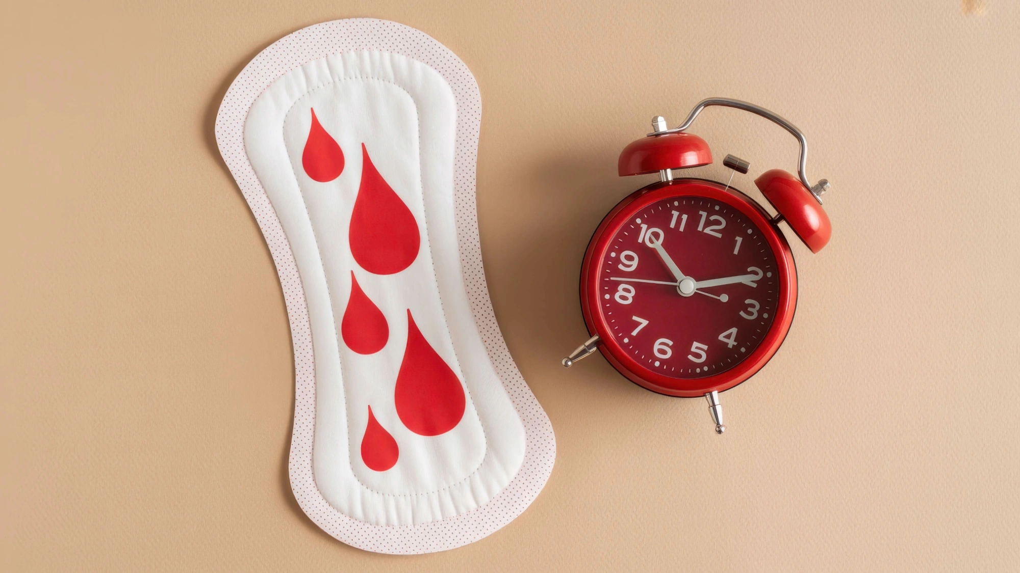 Sanitary pad with blood spots and an alarm clock, representing unexpected bleeding between periods.