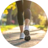A woman walking on a neighborhood sidewalk