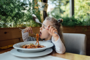 Girl eating pasta