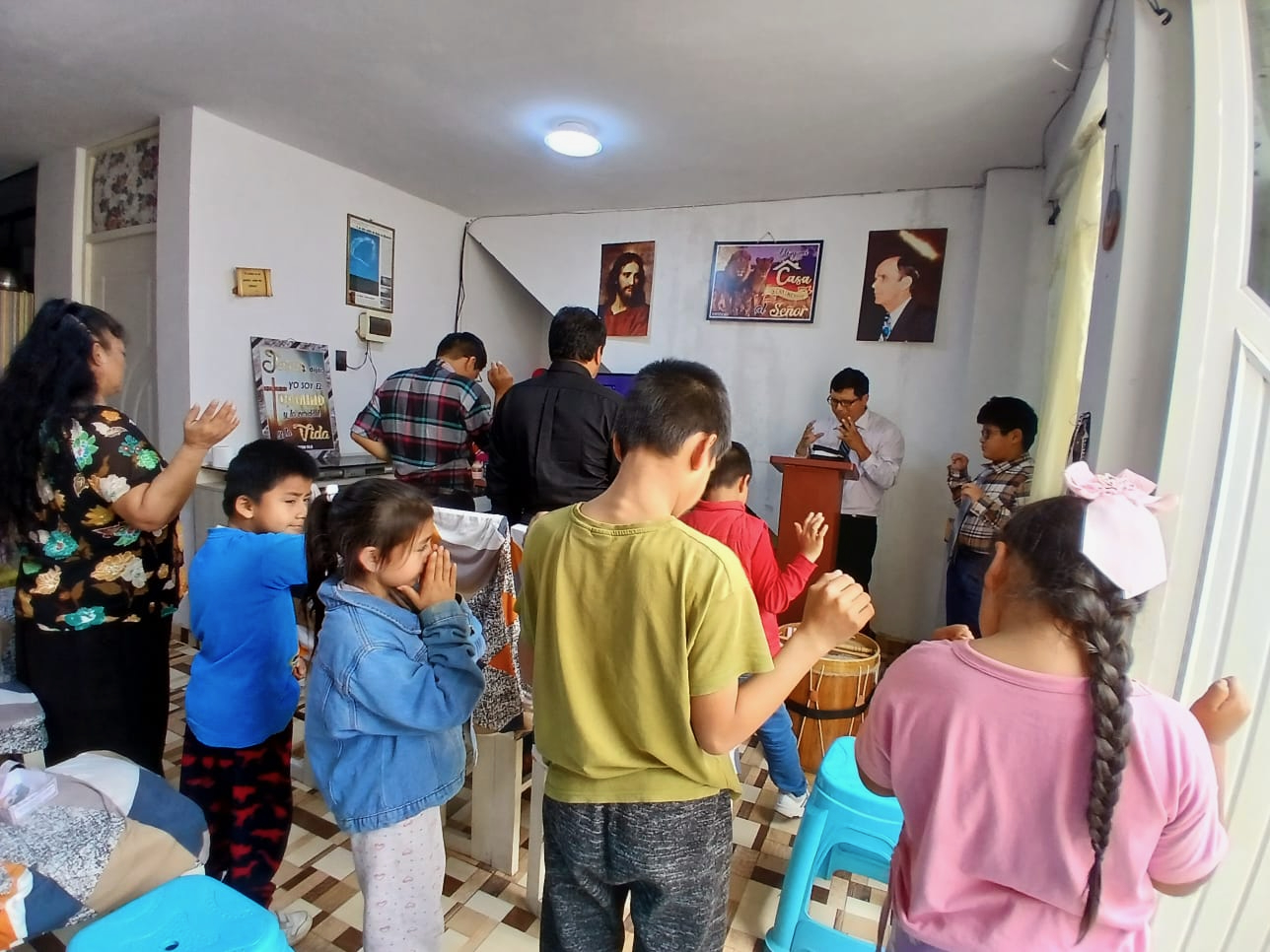 Children and families worshiping together during ministry work in Peru