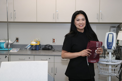 A correctional nurse holding medical devices. 