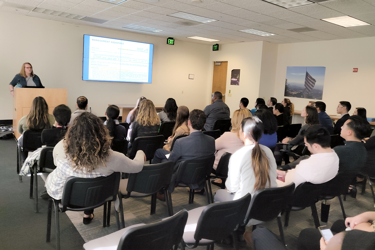 A woman training City Employees in a classroom setting.