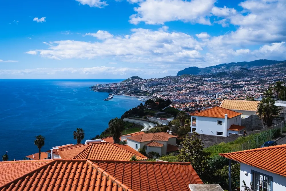 Vue panoramique de Funchal à Madère avec ses maisons colorées étagées sur les collines verdoyantes en bord de mer