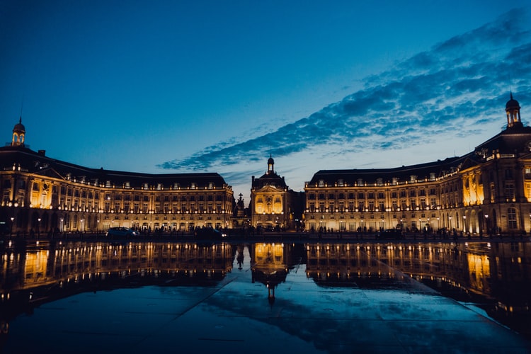 Le Miroir d'eau de Bordeaux illuminé la nuit, reflet magique du patrimoine architectural de cette ville française emblématique