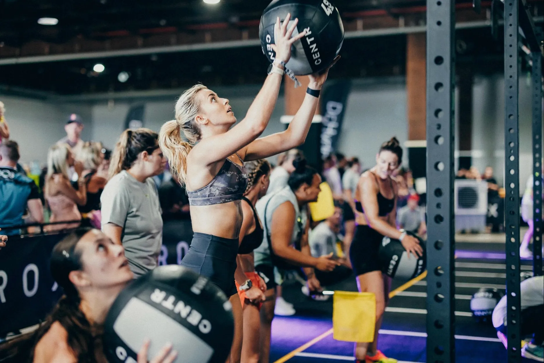 Athlete performing wall balls at a HYROX event